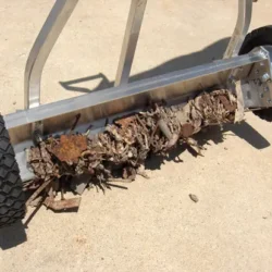 Wrap around feature so debris doesn't wipe off back of sweeper