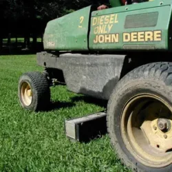 Hang sweeper under lawn mowing equipment and do two jobs at the same time