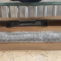 Step 10 bubble wrapped steel sliders and threaded rods go on top of two boxes