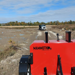 Mammoth road clearing magnetic sweeper and grader