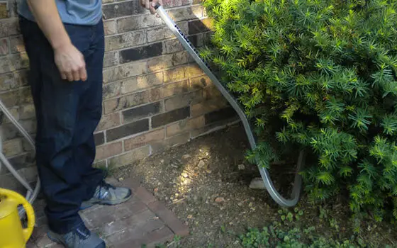 Powerstik In Use In Under Shrubs